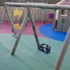 Commercial Flats Bristol swing frame and play tower with coloured wet-pour safety surfacing