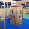 Commercial Flats Bristol play tower in a fenced courtyard playground with coloured wet-pour surfacing
