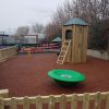 Sutherland Quarters fenced play area with tower carousel and rubber mulch surfacing