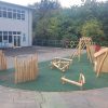 Kings Stanley natural playground with timber dens scramble pyramid balance play and rubber mulch surfacing