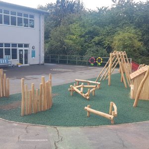 Kings Stanley natural playground with timber dens scramble pyramid balance play and rubber mulch surfacing