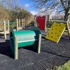 Green play tunnel and yellow traverse wall panel on Brockworth activity trail