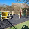 Balance beam and activity trail equipment with grass safety matting at Brockworth