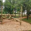 Side view of Burford clamber stack with timber climbing frame