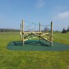 Clamber stack installed in an open grass play space