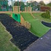 Grass bank play area with tunnel and safety surfacing at Minchinhampton School
