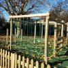 Timber rope play frame with net climbing section