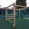 Installed playground play frame with rope climbing net