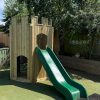 Wide view of timber playground turret with slide