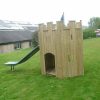 Side view of a compact timber playground turret with slide