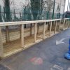 Shrubberies storage run beside ball-stop fencing
