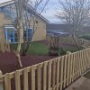 St Marys Quiet Area fenced play space overview with trees and timber boundary