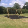 Two-bay timber playground swing frame in grass setting