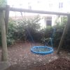 Basket swing installed in a playground setting
