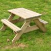 Timber picnic bench with attached seats on grass