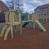 Ashchurch adventure play structure with climbing ramp and slide