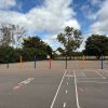Landscaping and decorative pencil posts in a playground setting