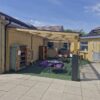 Timber school canopy creating a covered play area at Bussage
