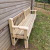 Angled view of the park bench showing its armrests and timber backrest